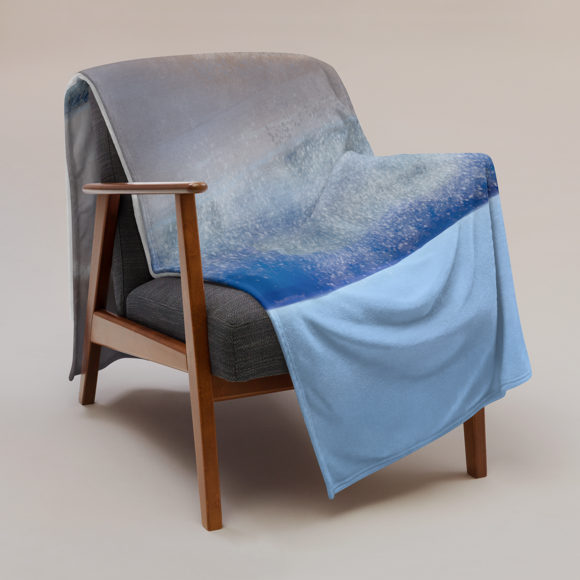 image of blanket with 'Waves of Love' printed on it draped over a chair